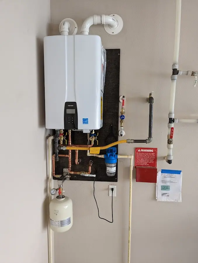 Professional plumber installing copper piping in a Sullivan home